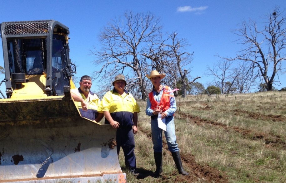 Mark and Peter Rodwell, ripping contractors from Bombala with Lauren Van Dyke, Dieback Project Manager with new deep rip lines in foreground with backdrop of dead trees. Photo: Lachlan Ingram